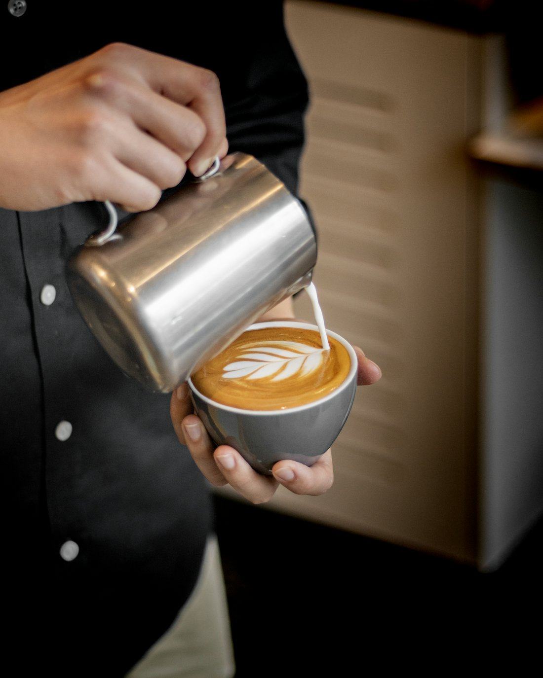 Barista pouring a latte